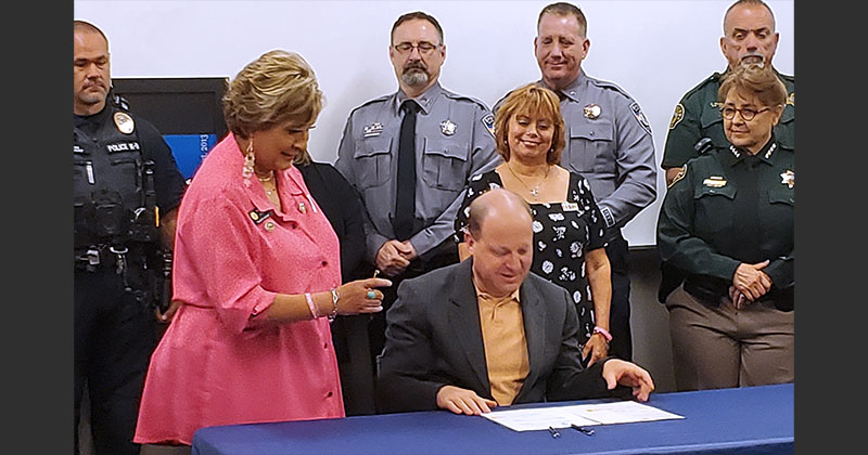 Governor Jared Polis signs greyhound simulcast ban with Majority Leader Monica Duran and GREY2K President Christine Dorchak (June 2, 2023)
